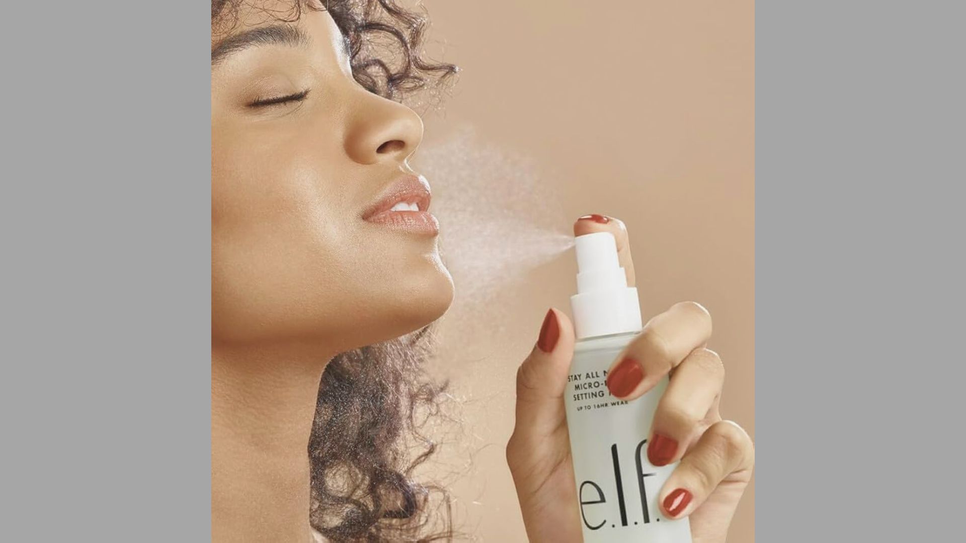 A woman is blowing a fine mist onto her face, enhancing her skincare routine.