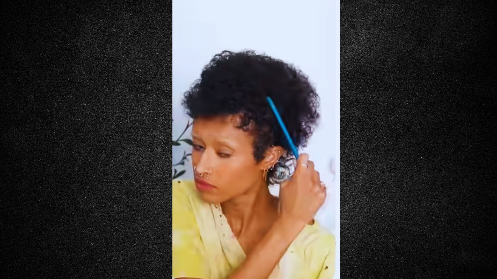 A woman grasping a blue toothbrush, indicating she is about to brush her teeth.