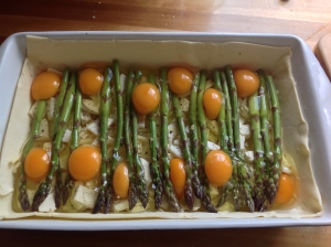Crack the eggs over the asparagus