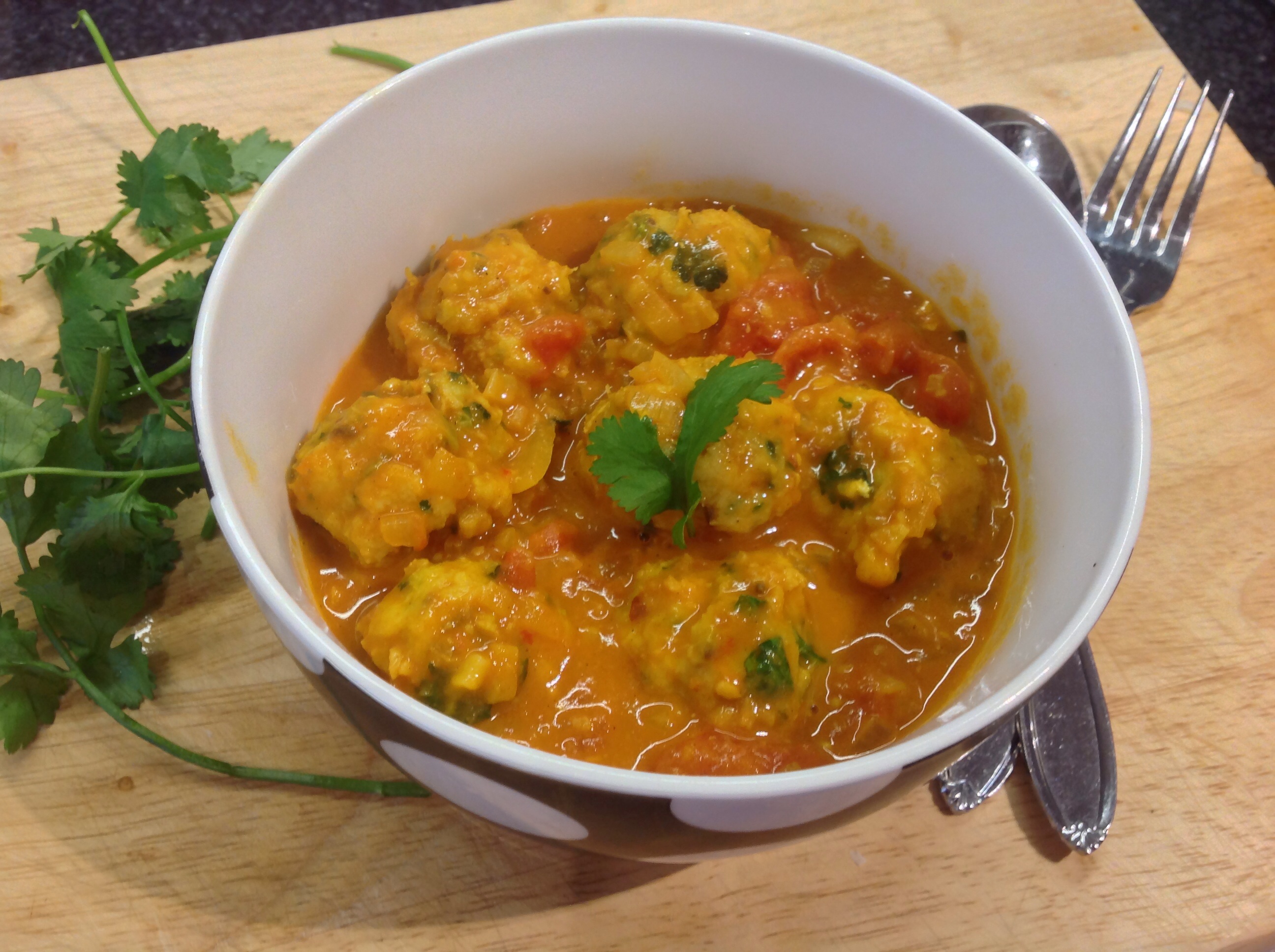 Tomato and Coconut soup with fish dumplings