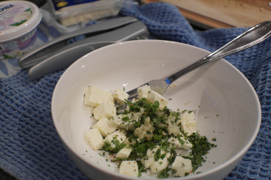 Place the cream cheese, feta, herbs and garlic in a bowl. Mash together with a fork.