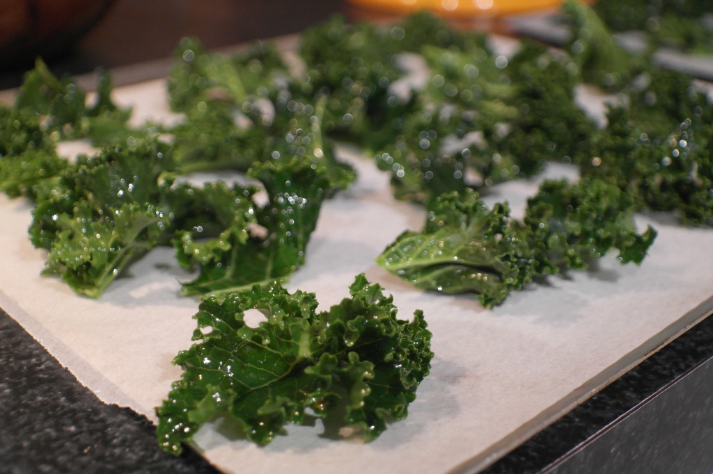 Line two baking trays with baking paper. Spread kale leaves out. Place trays in a pre-heated oven (180 degrees, normal fan bake). Mine took 11 minutes, but keep a close eye on them after 10 minutes: They go brown really quickly. You want them just starting to colour.