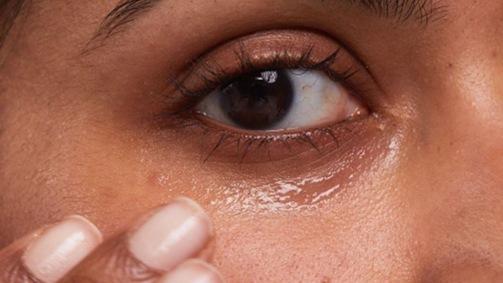 A woman with a tear in her eye, conveying deep emotion and vulnerability.
