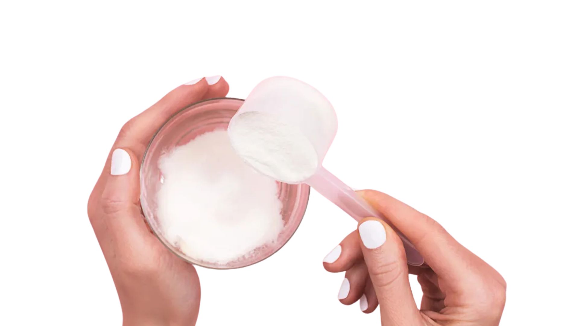 A woman holds a spoon with a scoop of sugar, preparing to add it to a recipe or beverage.