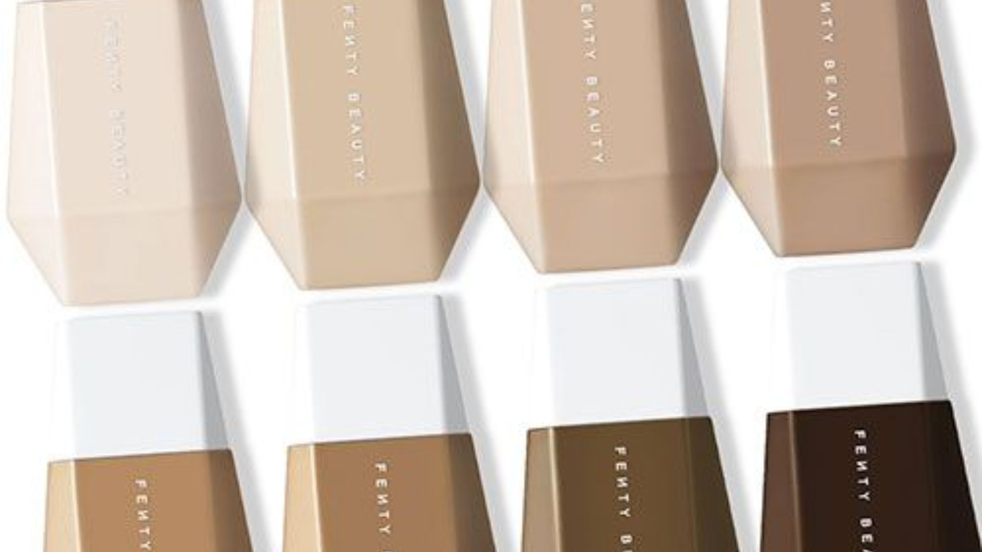 Different foundation shades arranged in a spectrum, highlighting options for various skin tones.