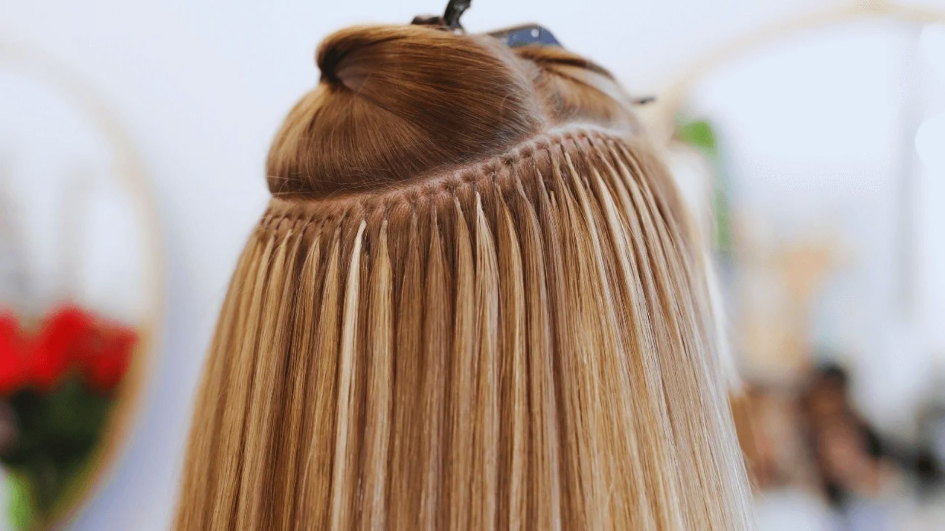 A close-up of a woman’s hair being braided into a long braid, highlighting the use of K tips hair extensions for enhancement.