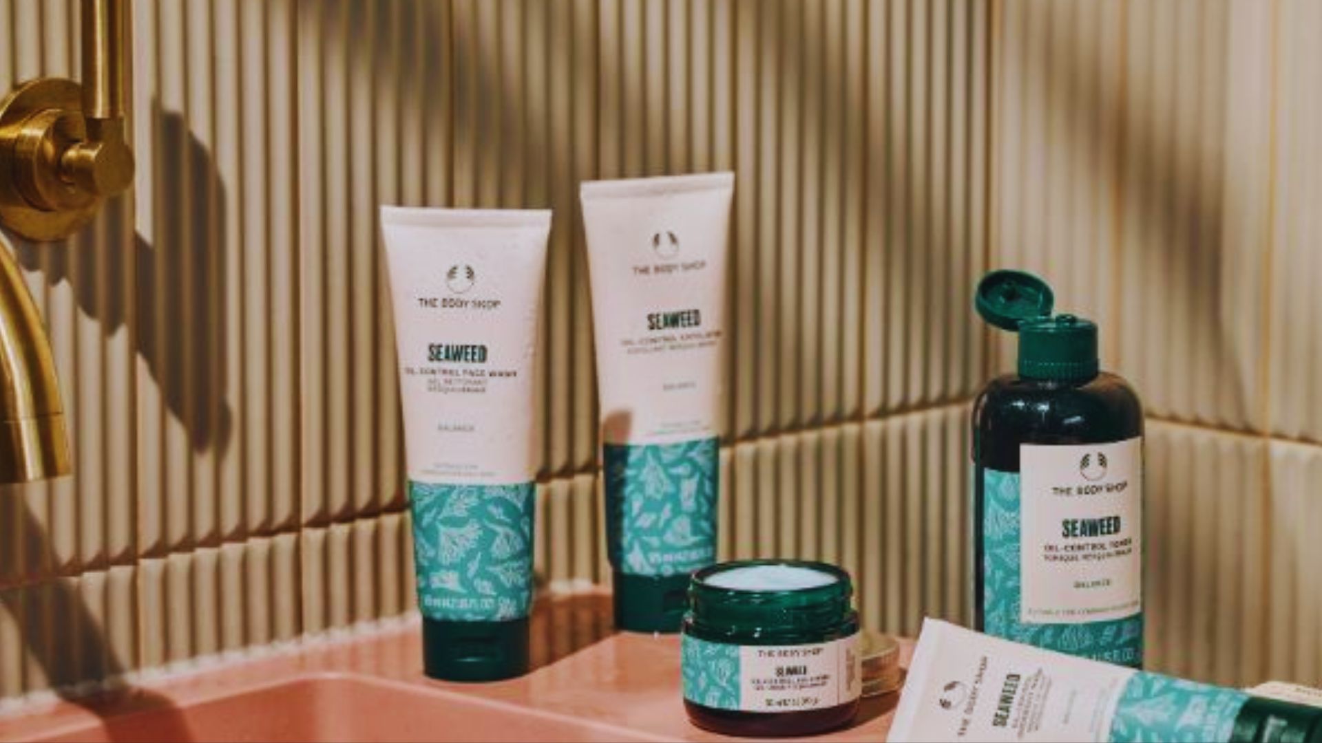 A bathroom sink with a toothbrush and a tube of toothpaste placed neatly beside it.