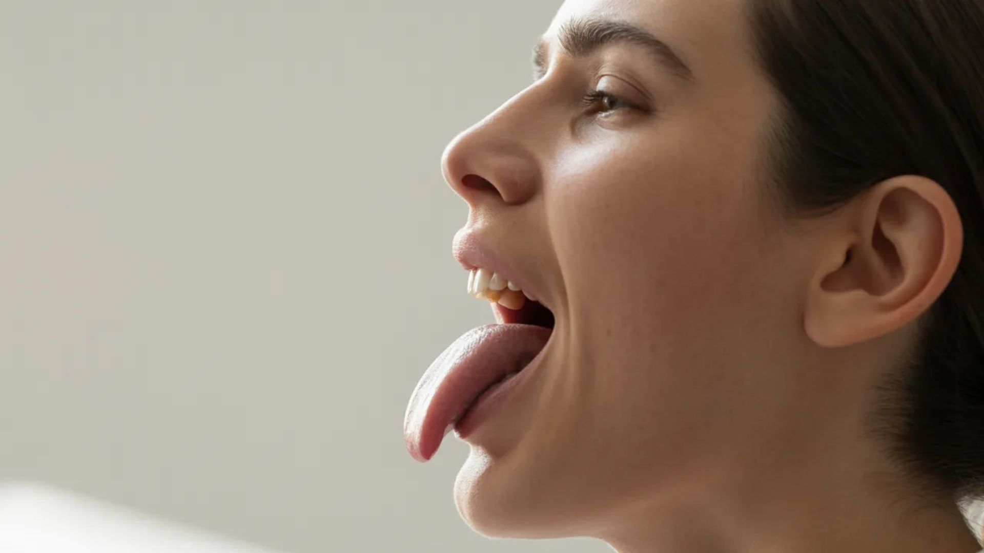 3. A woman playfully sticking her tongue out while making direct eye contact with the camera.