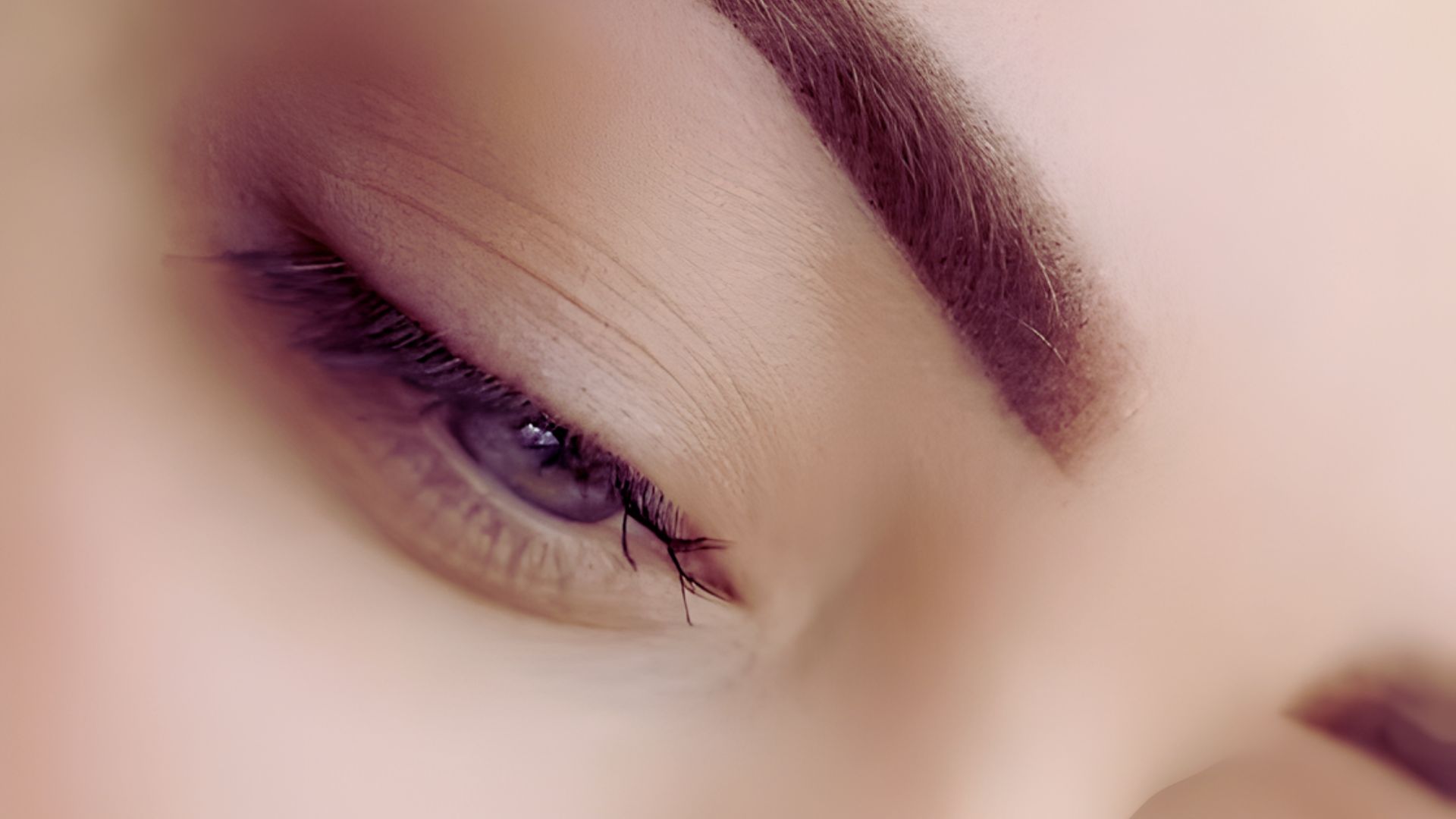 Close-up of a woman's eye showcasing dramatic long eyeliner, emphasizing her eyelashes and eye shape.