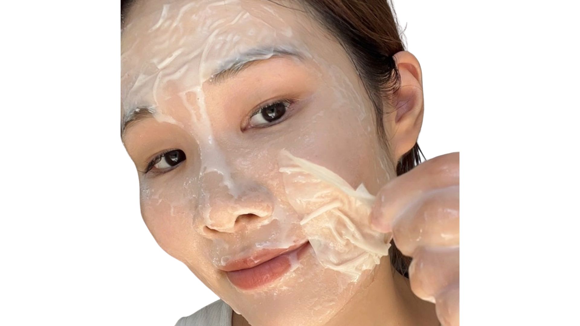A woman applies a facial mask to her face, focusing on skincare and self-care routines.