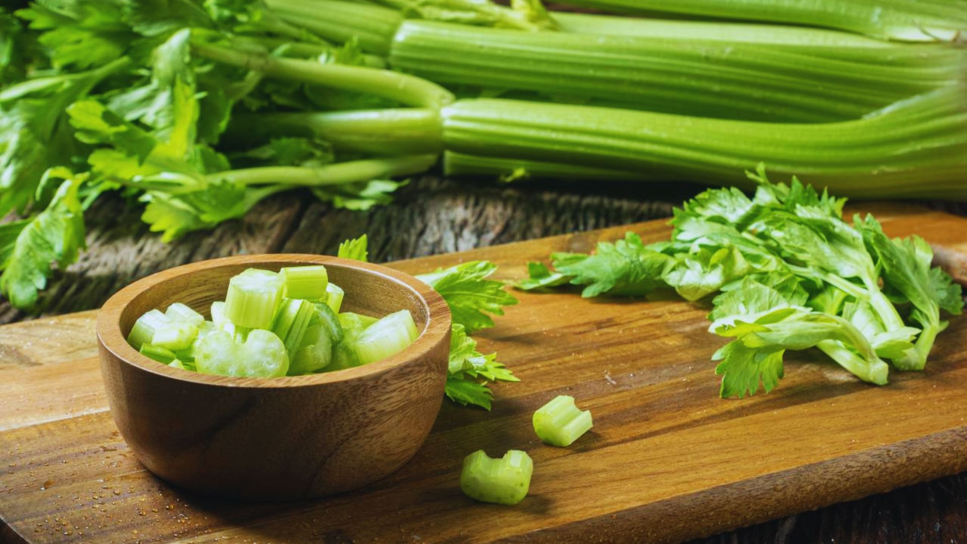 Fresh celery arranged on a cutting board, intended for use in skincare preparations.