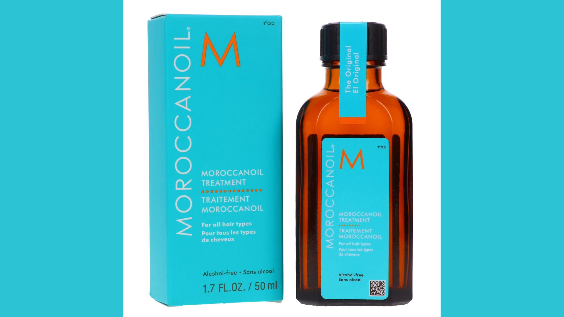 A bottle of Moroccan oil hair treatment with a sleek design, placed on a wooden surface, surrounded by natural elements.