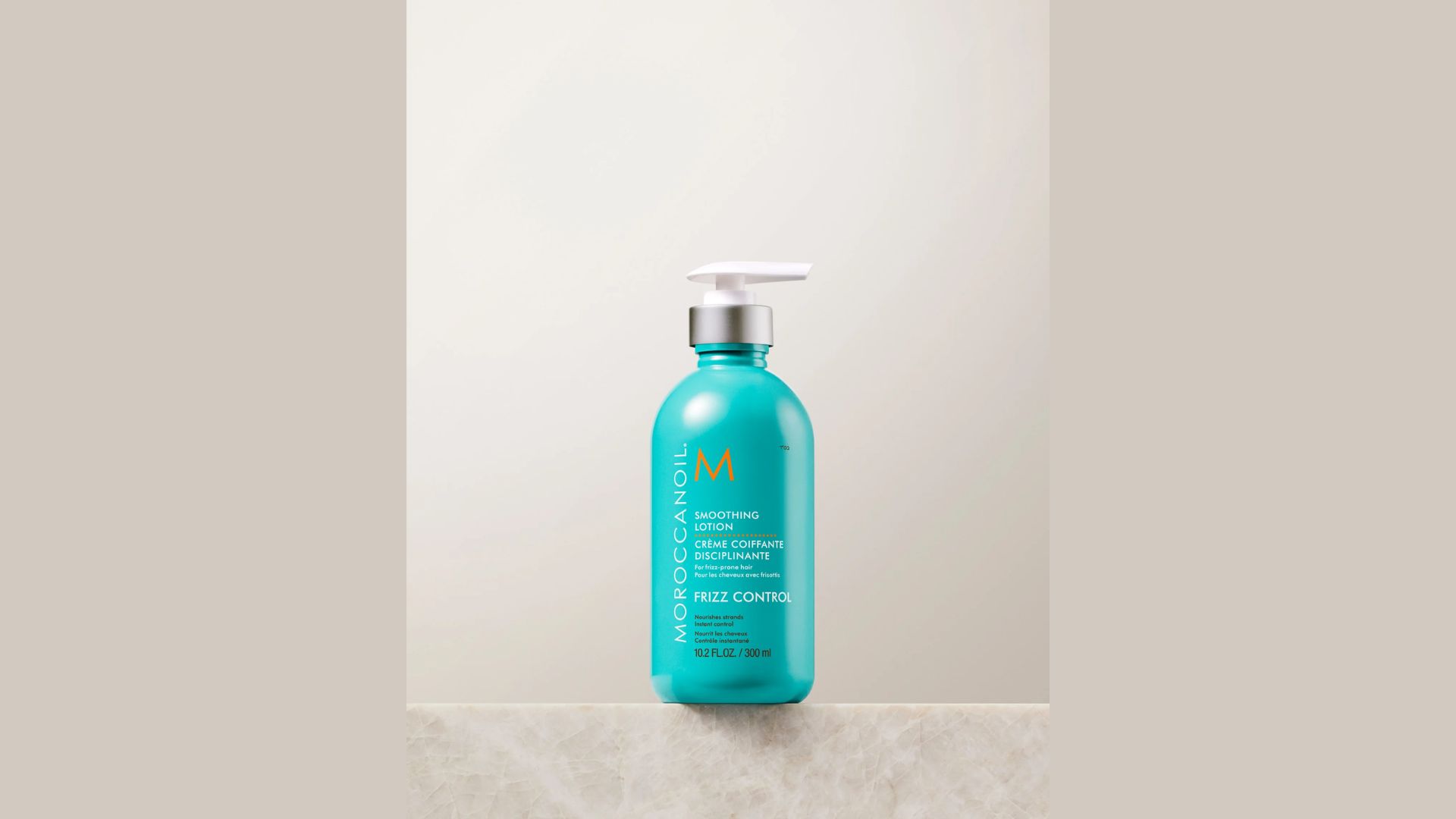 A shampoo bottle resting on a polished marble countertop, highlighting the contrast between the bottle and the surface.