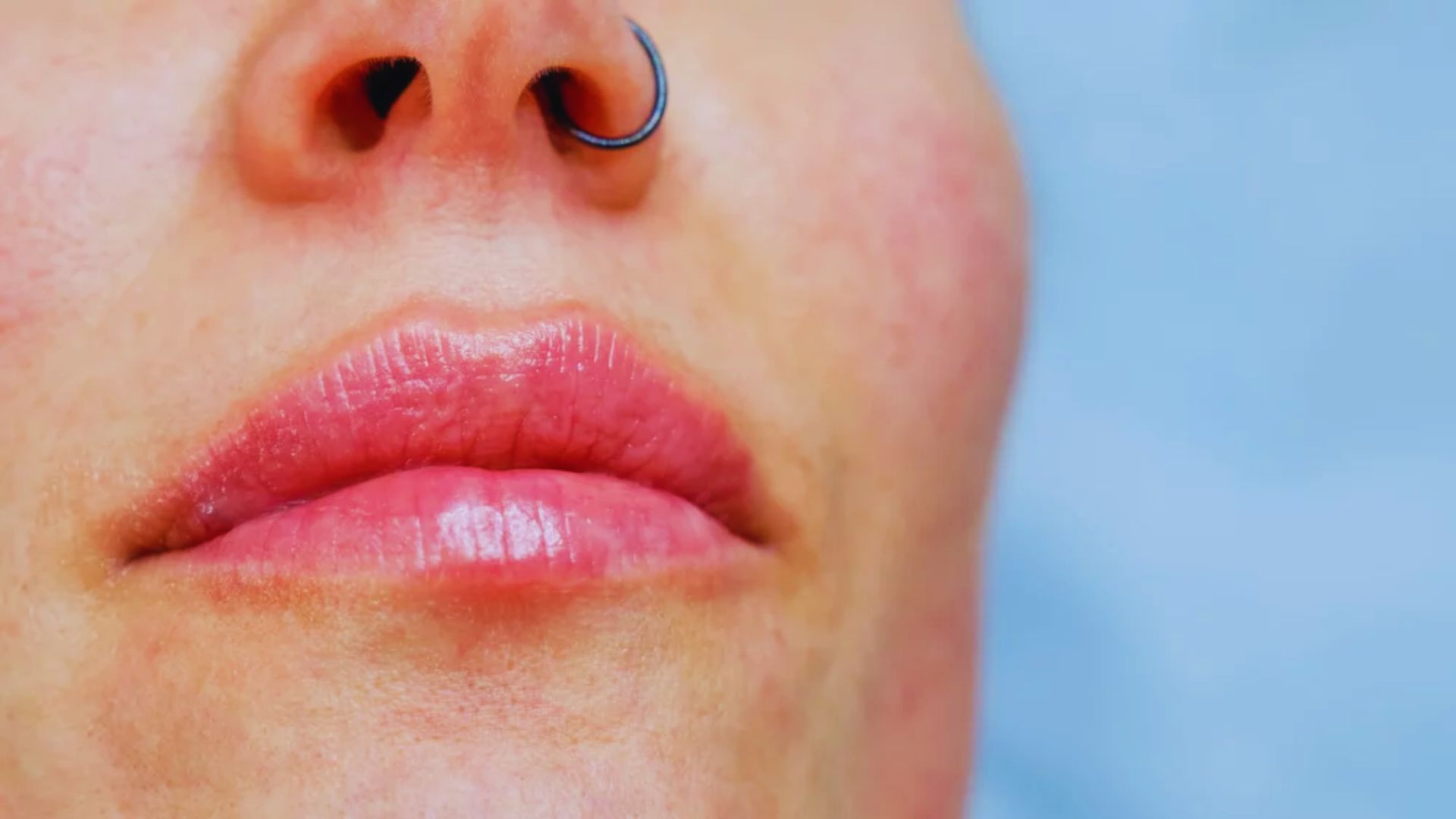 A woman with a nose piercing and a decorative nose ring, showcasing her style and individuality.