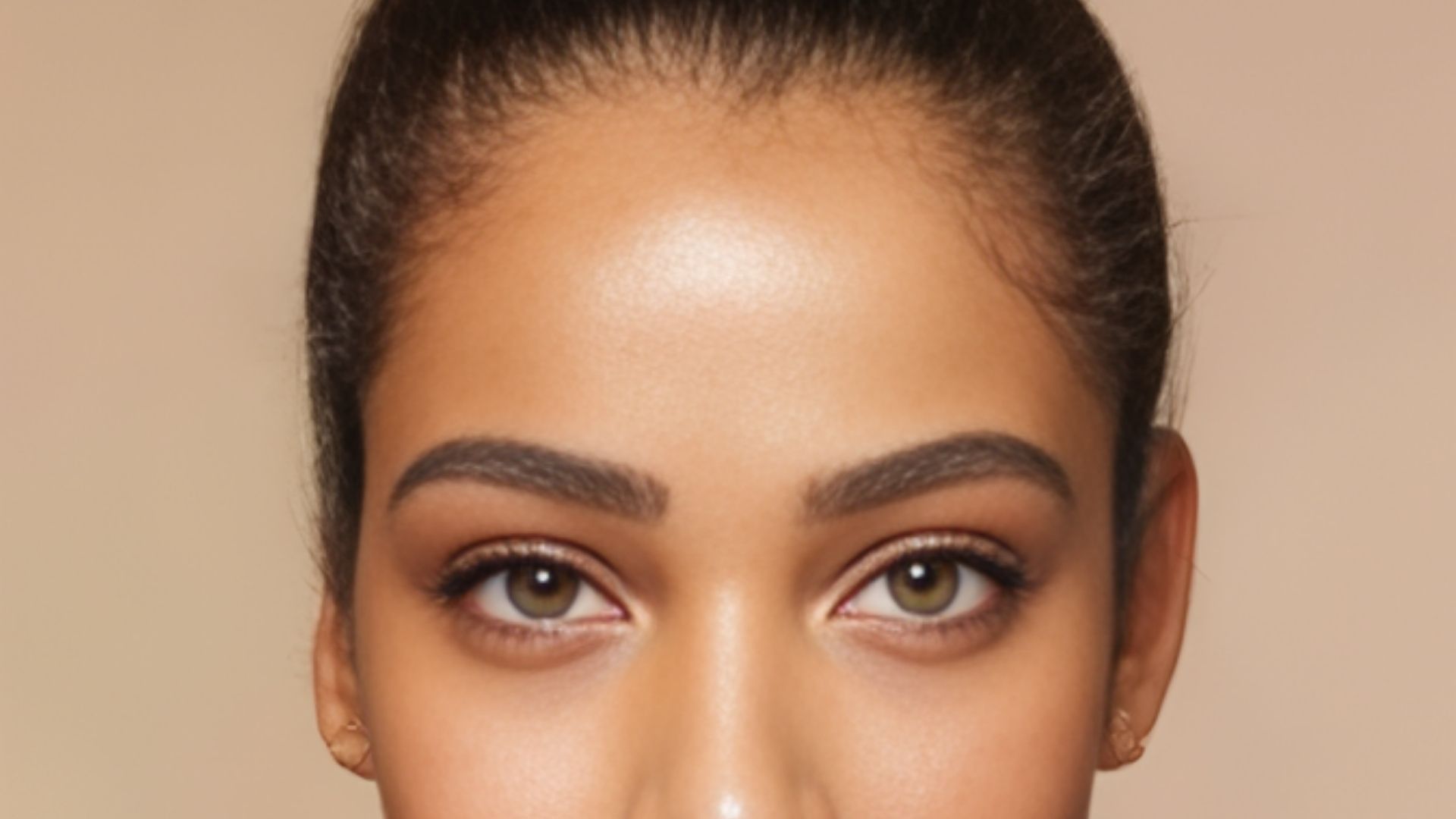 A woman with a vibrant makeup look and a bright smile, exuding confidence and joy.