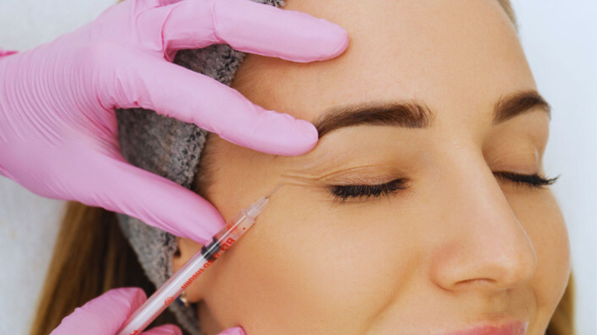 Image depicts a woman undergoing eyebrow grooming, highlighting the steps involved in her beauty enhancement