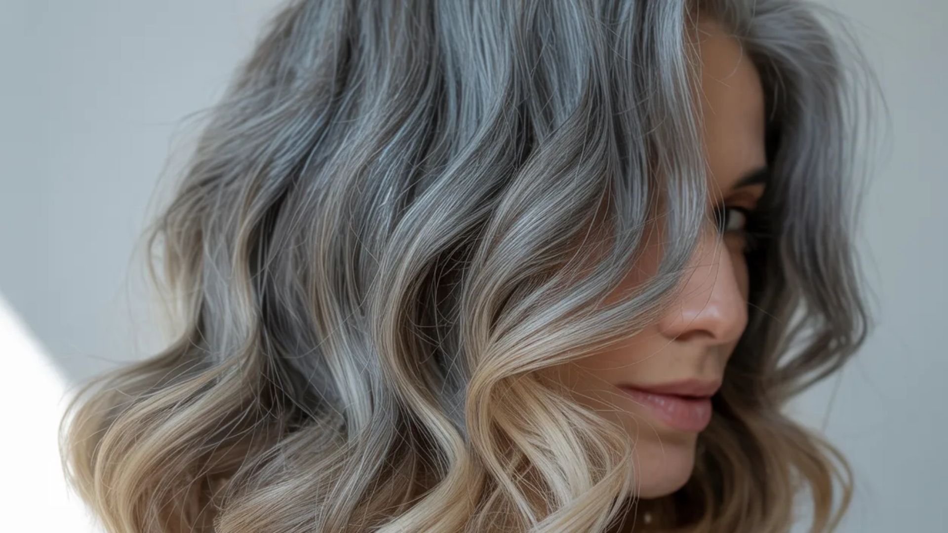 A woman with gray hair styled in a wavy bob, showcasing her elegant and sophisticated appearance.