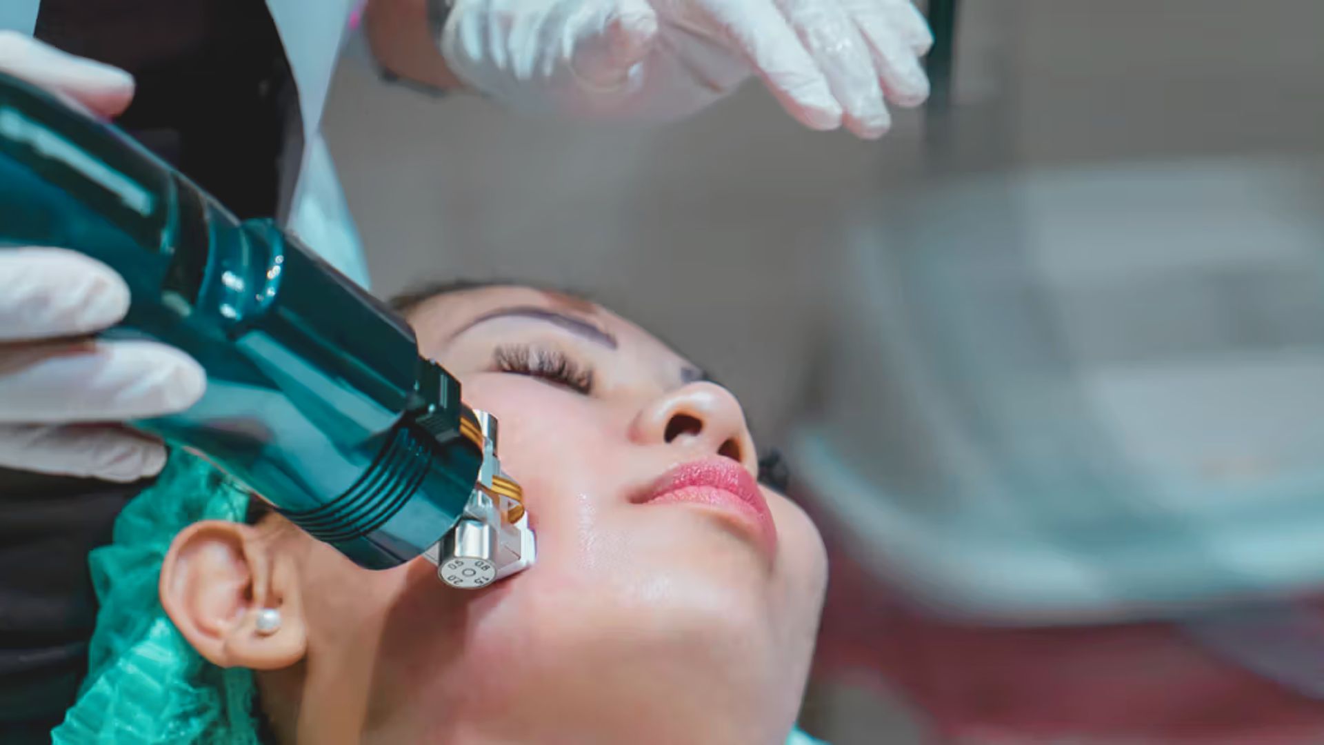 A woman receiving a facial treatment using a specialized machine in a spa setting.