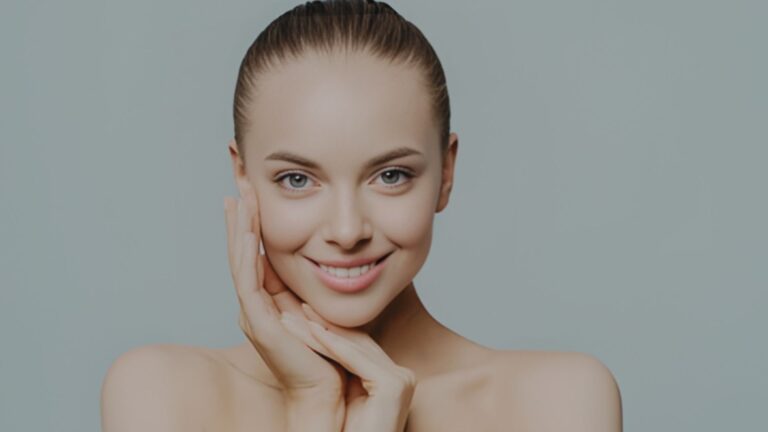 Smiling woman with clear skin, radiating beauty and confidence.