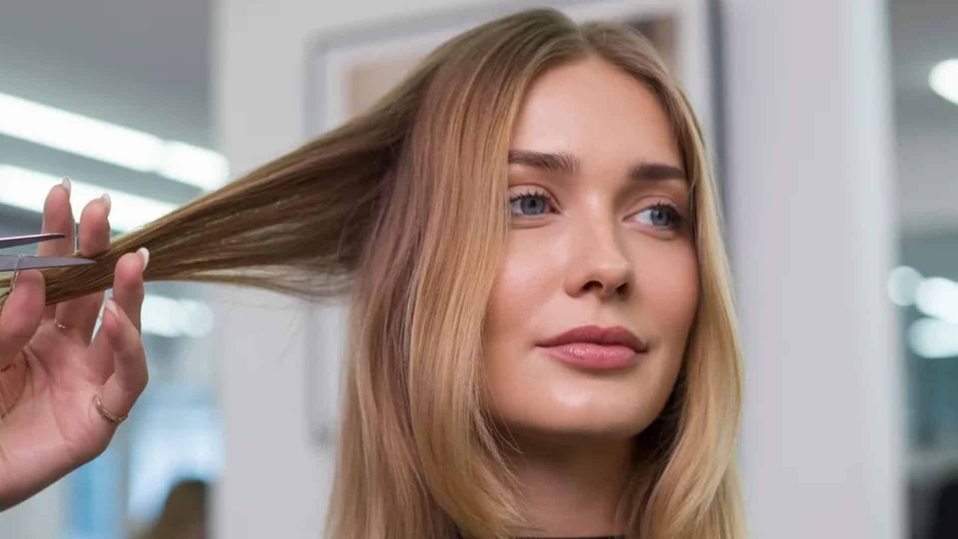 A woman receives a haircut from a professional hairdresser in a stylish salon environment.