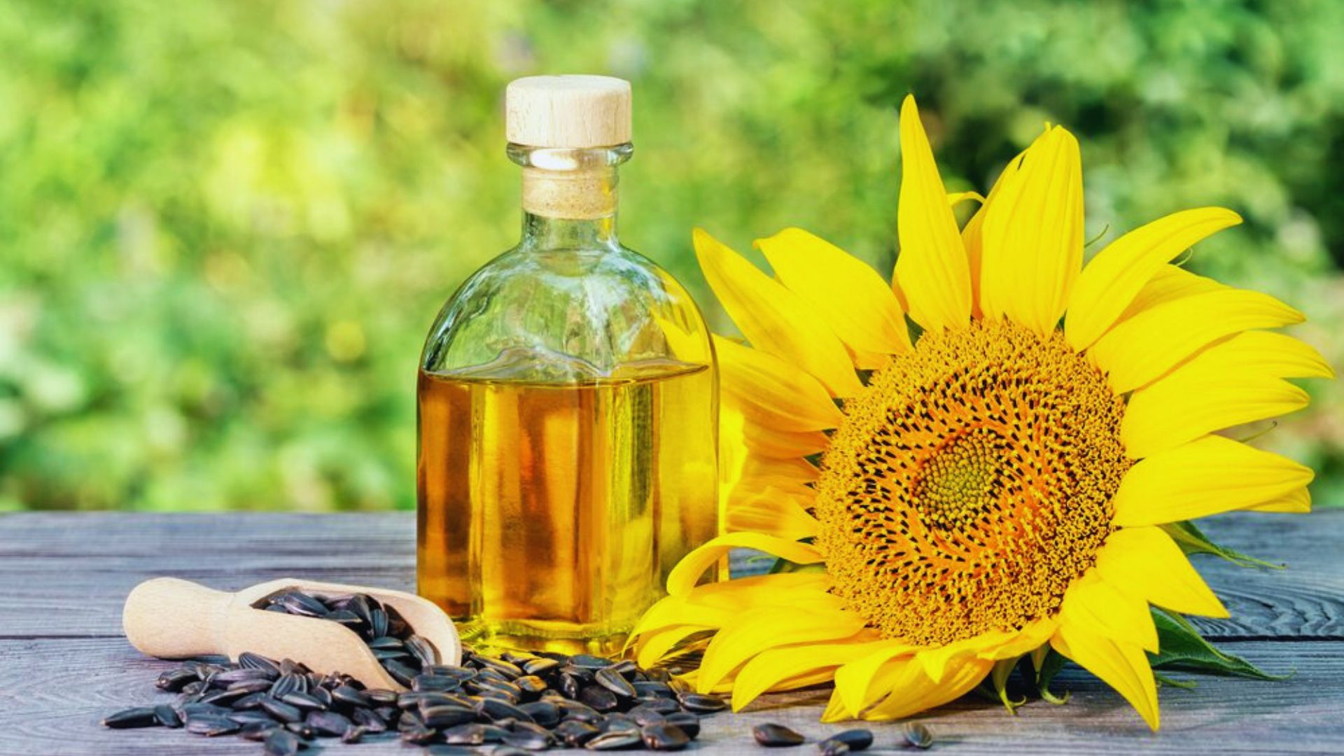 Sunflower oil and sunflower seeds displayed on a rustic wooden table, highlighting their natural textures and colors.