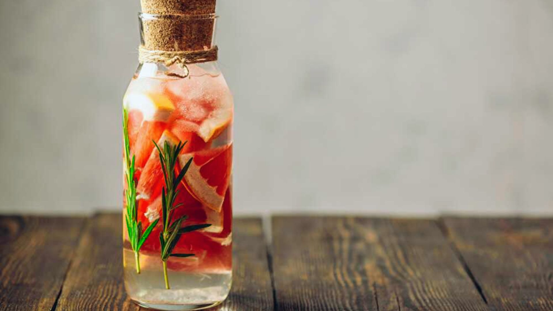 A clear bottle filled with water and colorful fruit slices, showcasing a refreshing beverage option.
