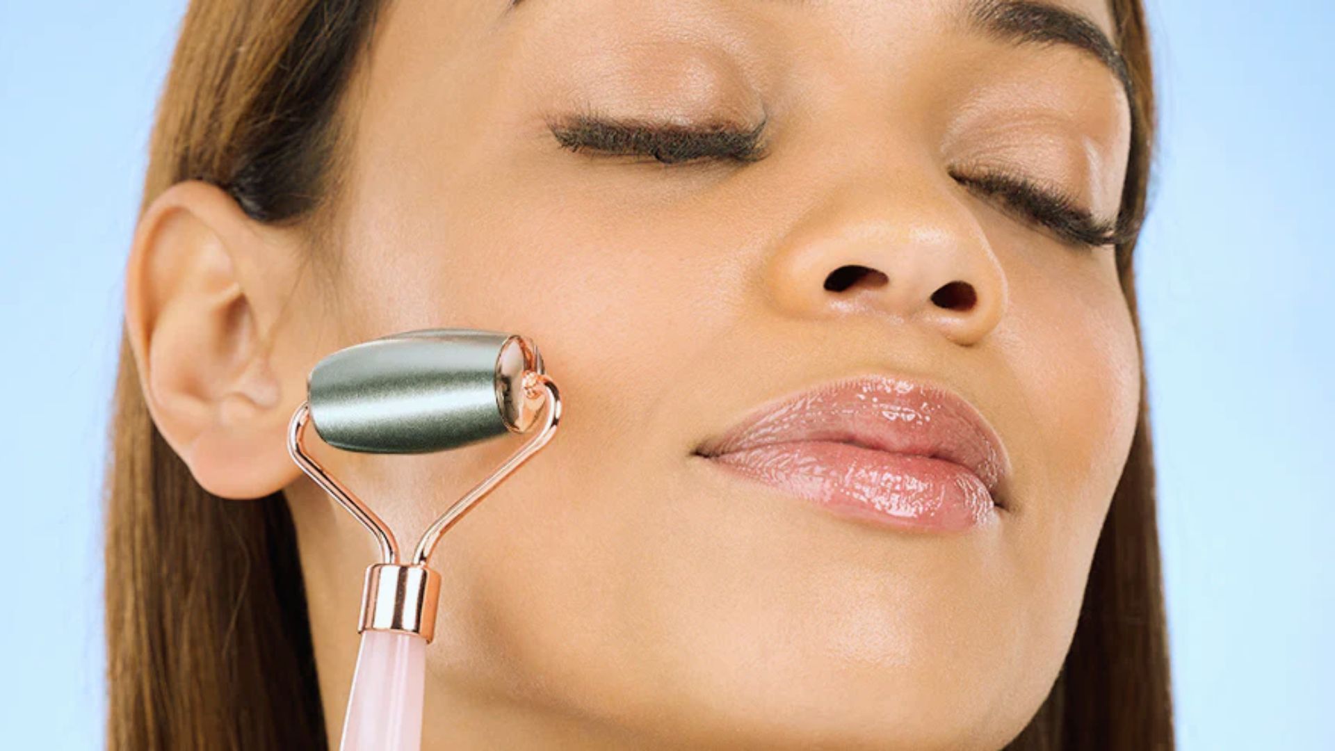 A woman is using a facial cleansing device to clean her face, focusing on her skincare routine.