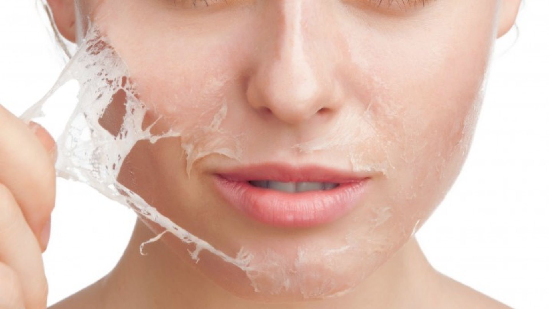A woman applies facial cream to her skin, focusing on a smooth and rejuvenating skincare routine.