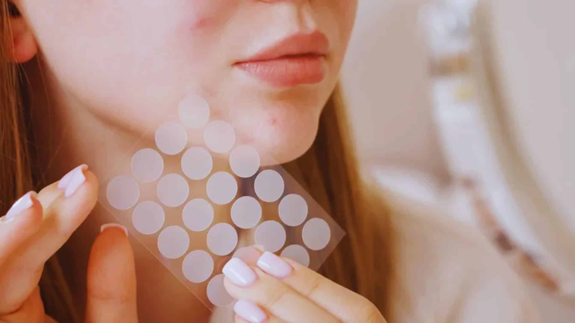 A woman applying a colorful sticker to her cheek, smiling as she enhances her playful look.