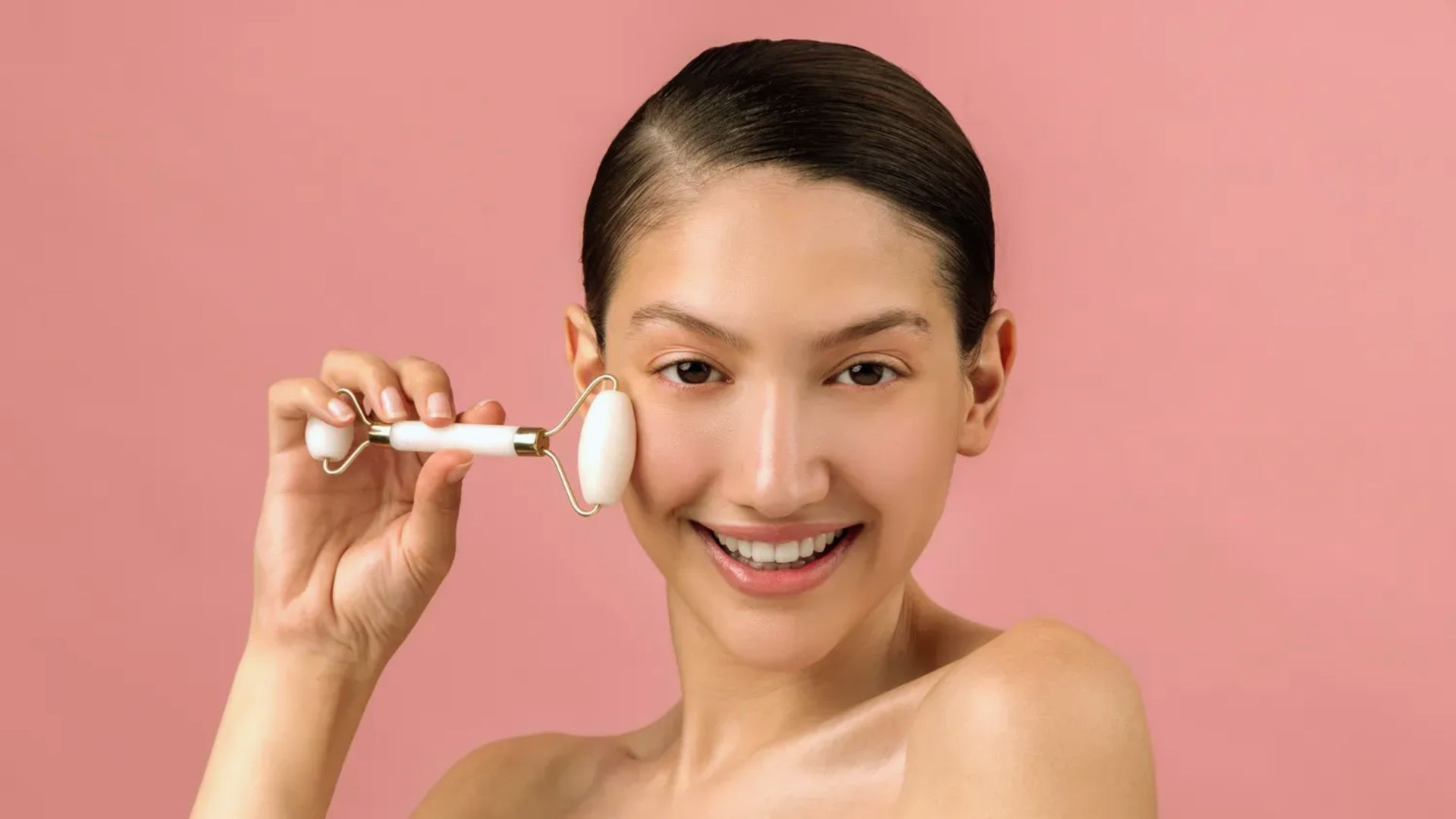 A smiling woman holds a white toothbrush, showcasing her enthusiasm for dental hygiene.