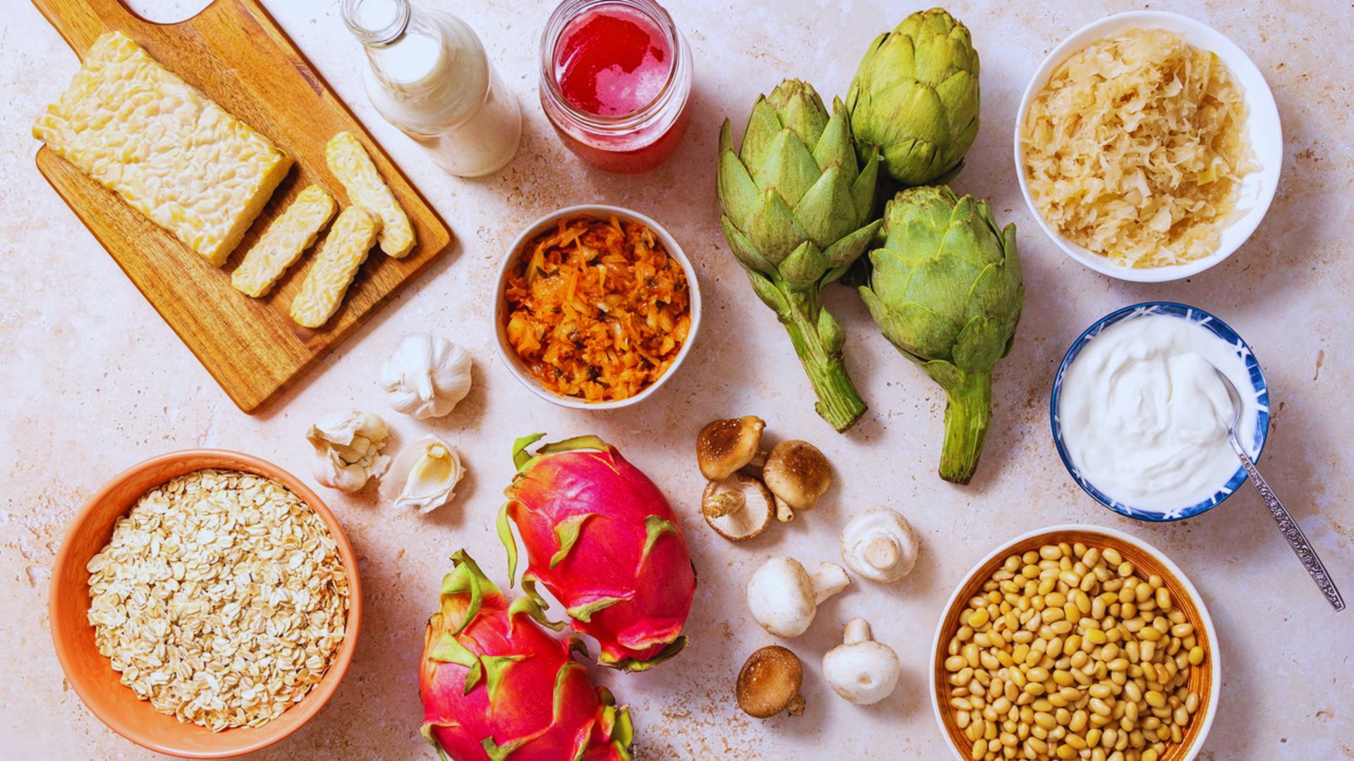 A colorful assortment of vegetables, nuts, and grains displayed together on a wooden surface.