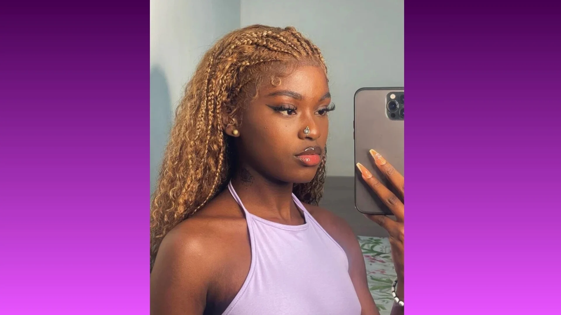 A woman with long braided hair takes a mirror selfie. She's wearing a light purple halter top, with a serene expression. The background gradient is purple.