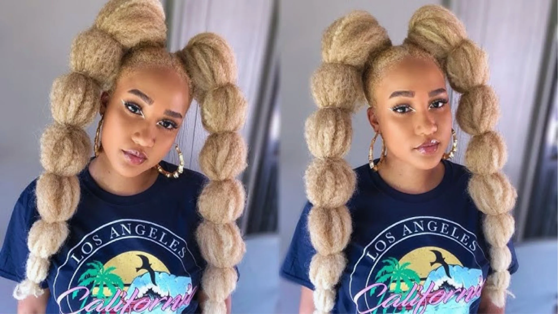 A woman with long, thick, blonde hair styled in multiple bubble ponytails. She wears a "Los Angeles, California" t-shirt and gold hoop earrings, conveying a confident and trendy look.