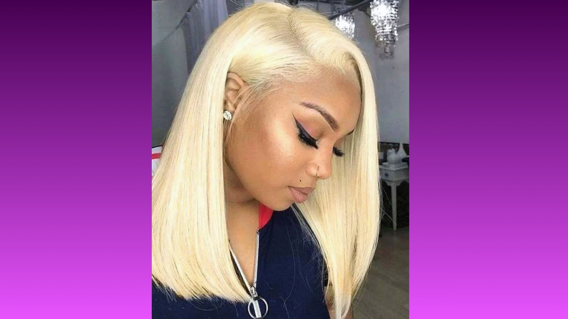 A woman with sleek, straight platinum blonde hair styled in a chin-length bob gazes downward. She wears black eyeliner and earrings, set against a purple gradient background.