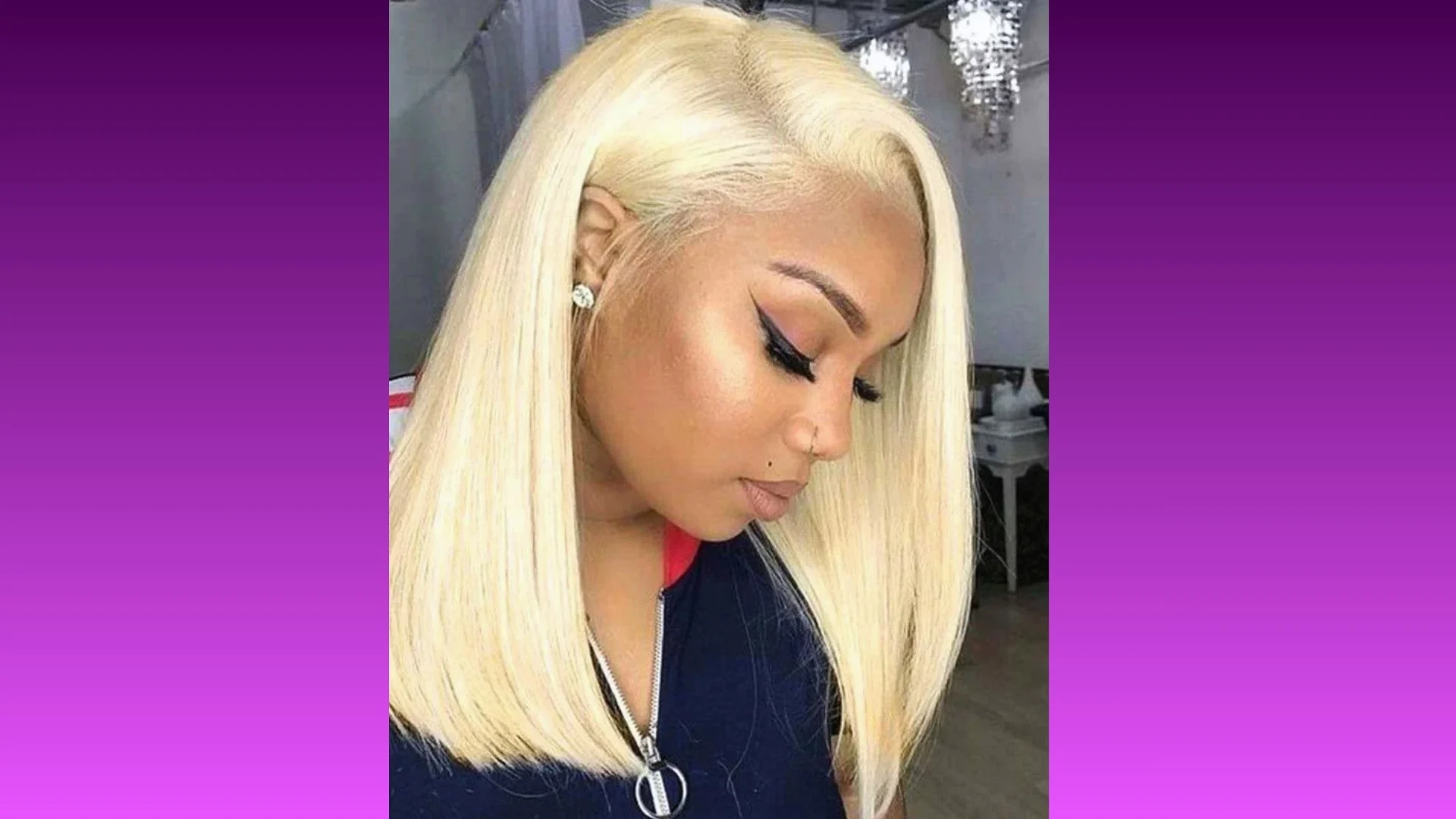 A woman with sleek, straight platinum blonde hair styled in a chin-length bob gazes downward. She wears black eyeliner and earrings, set against a purple gradient background.