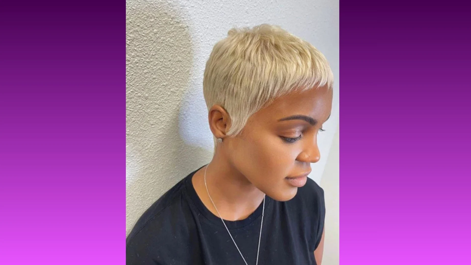 A woman with a sleek platinum blonde pixie cut gazes downward against a textured white wall. The image conveys a calm, stylish elegance.