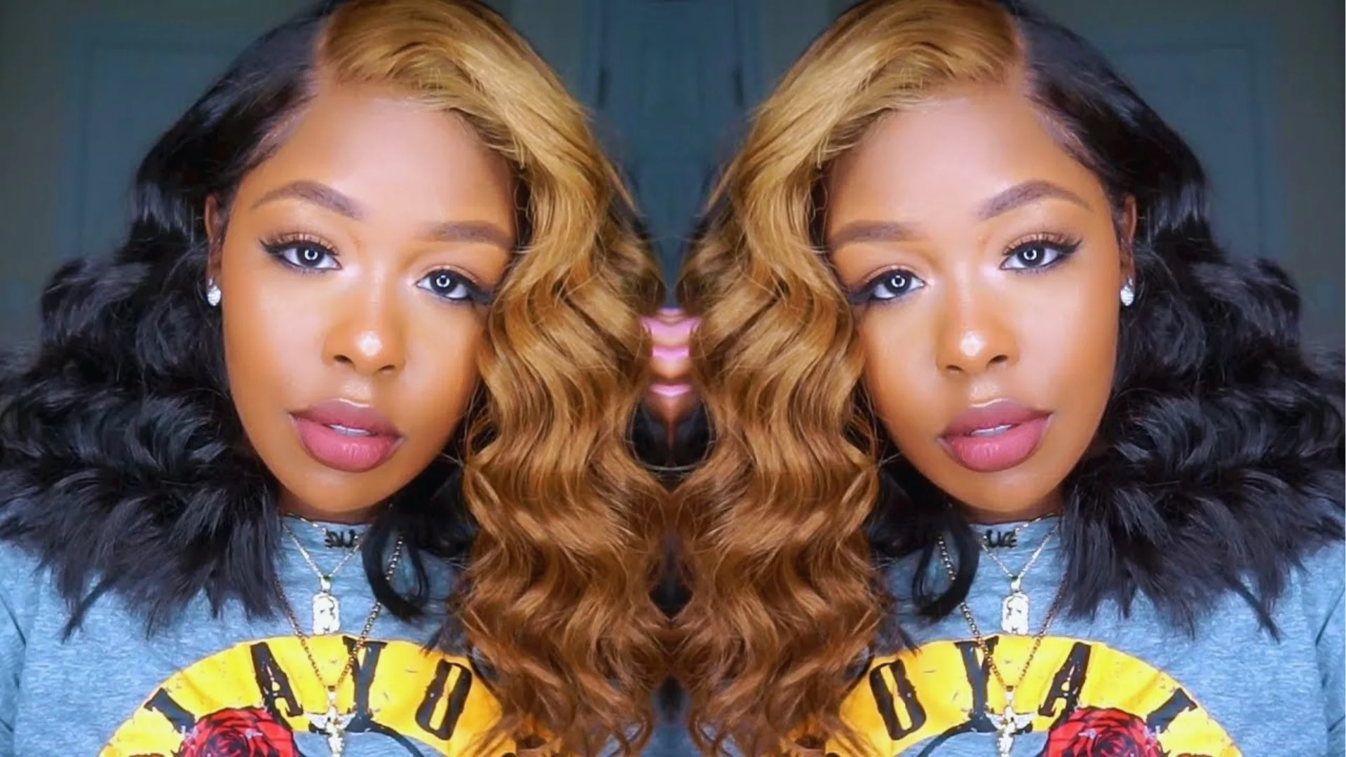 Woman with wavy, two-tone hair in black and honey blonde, wearing a graphic tee. The mirrored image exudes a bold and stylish vibe.