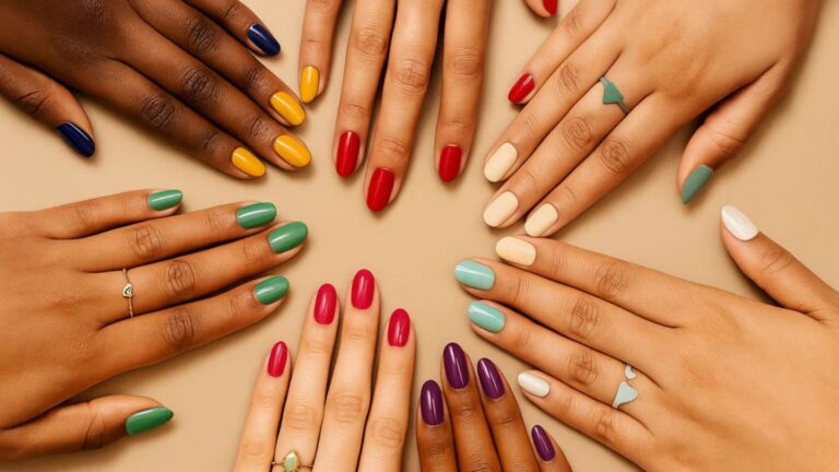 A circle of diverse hands displays various colored nail polish—yellow, red, green, and more—against a beige background, conveying unity and creativity.