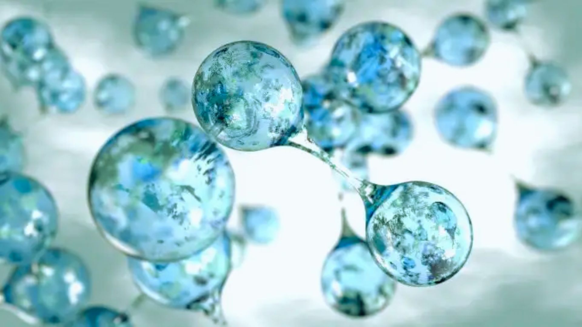 Blue translucent spheres of varying sizes float against a soft, blurred background. They convey a sense of lightness and fluidity, resembling bubbles.