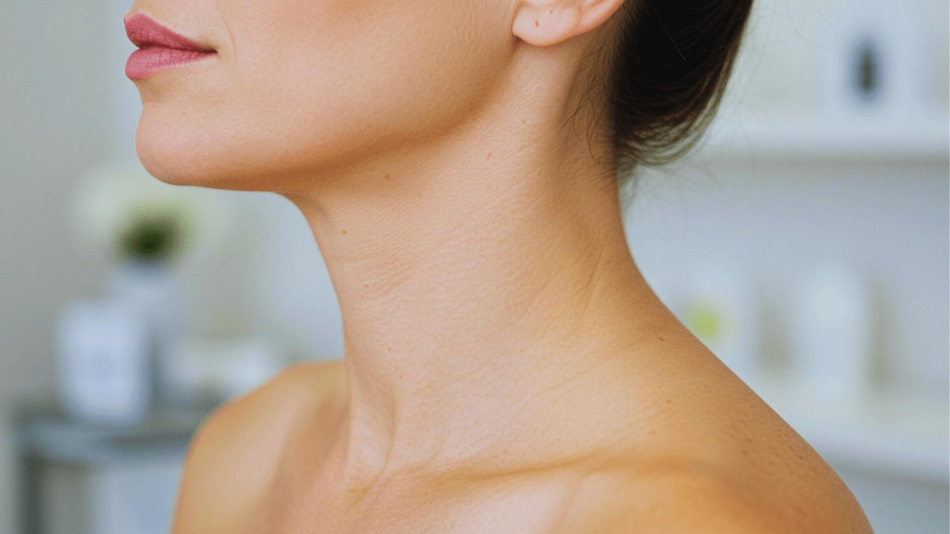 Close-up side view of smooth female neck and jawline after Botox treatment for neck bands in clinical setting.