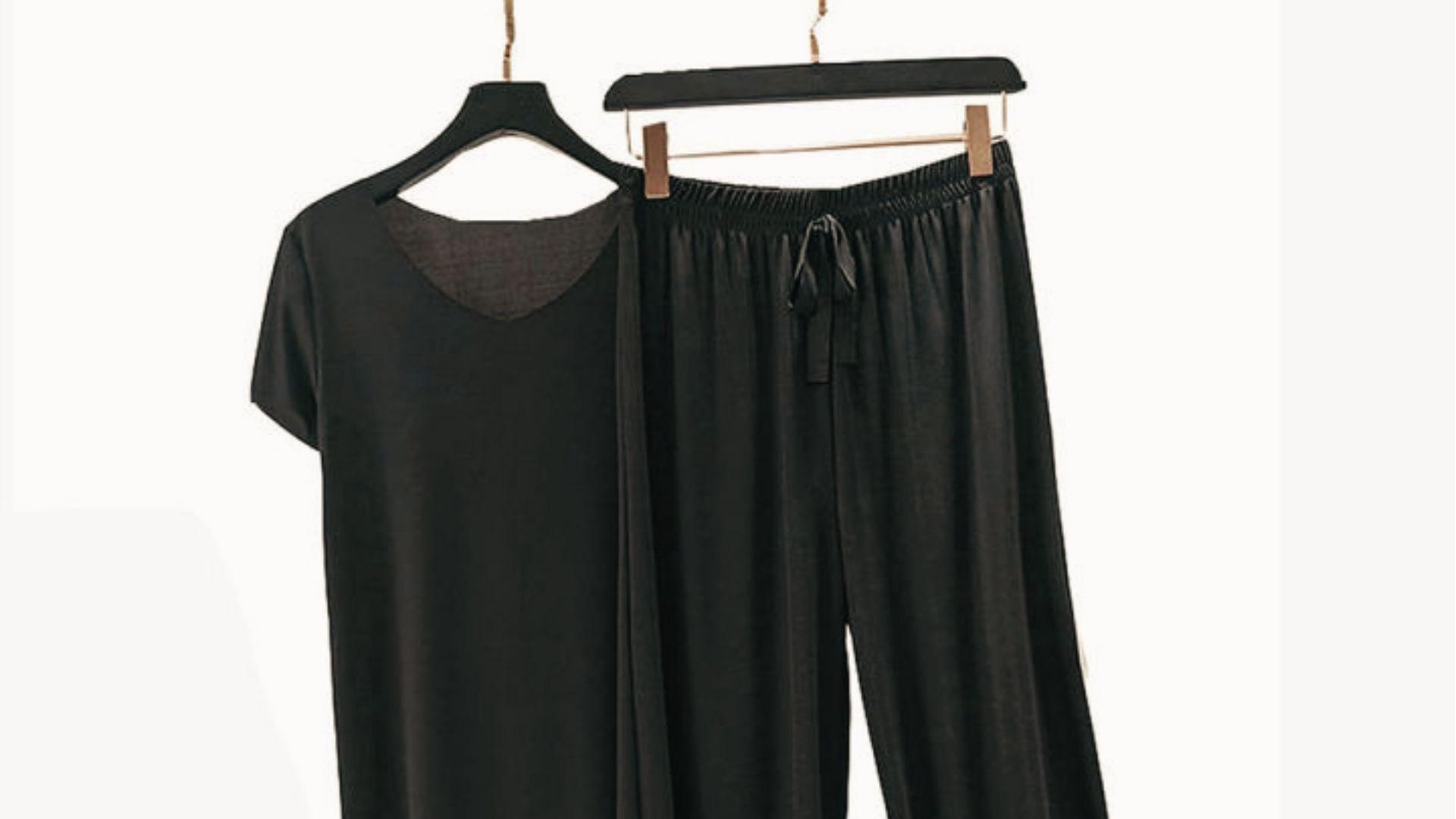 Loose black tee and flowy drawstring pants on hangers, perfect dark outfit to wear after a spray tan