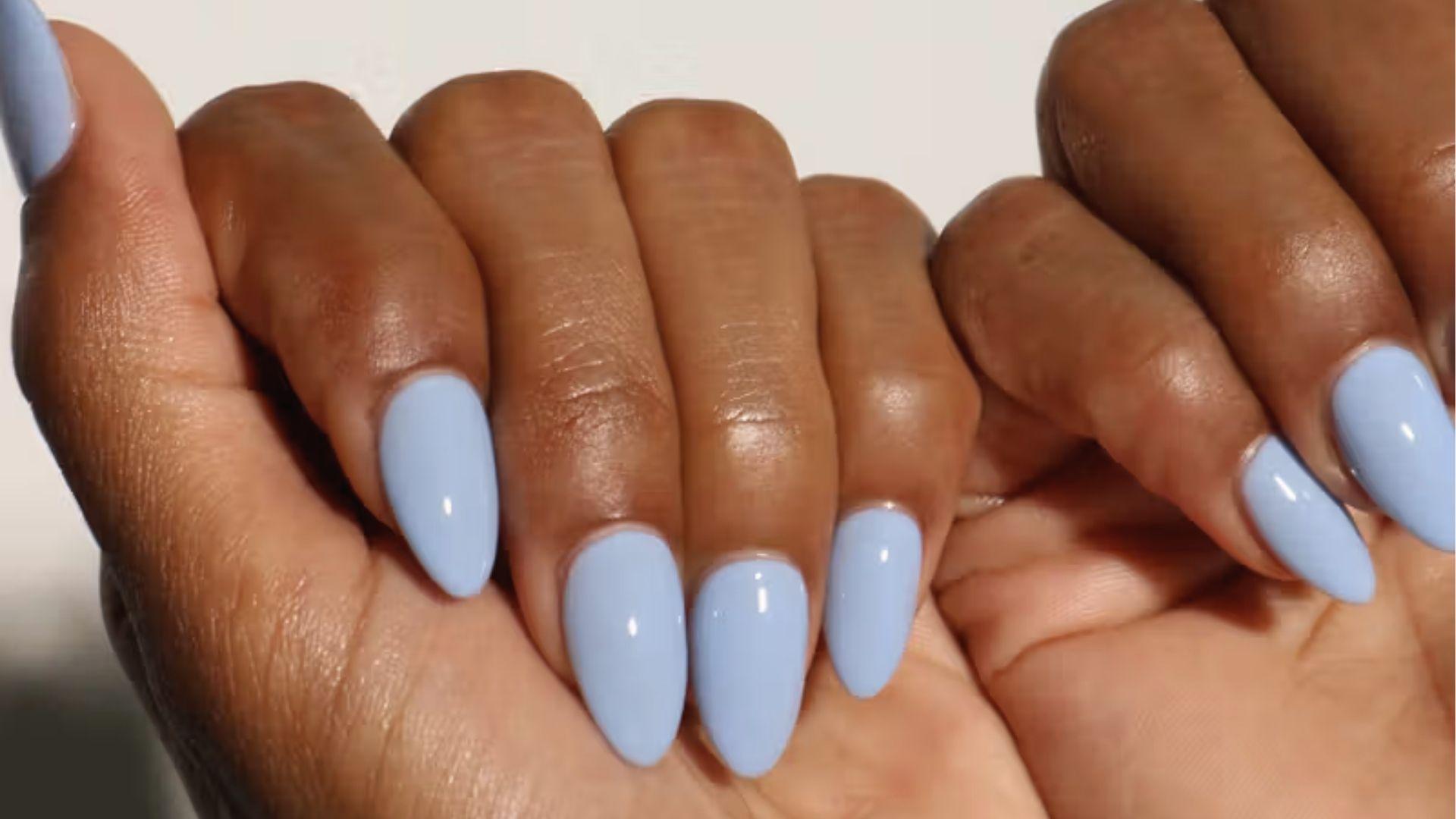 Short almond dip nails in glossy solid pastel baby blue for a clean, soft and versatile look.