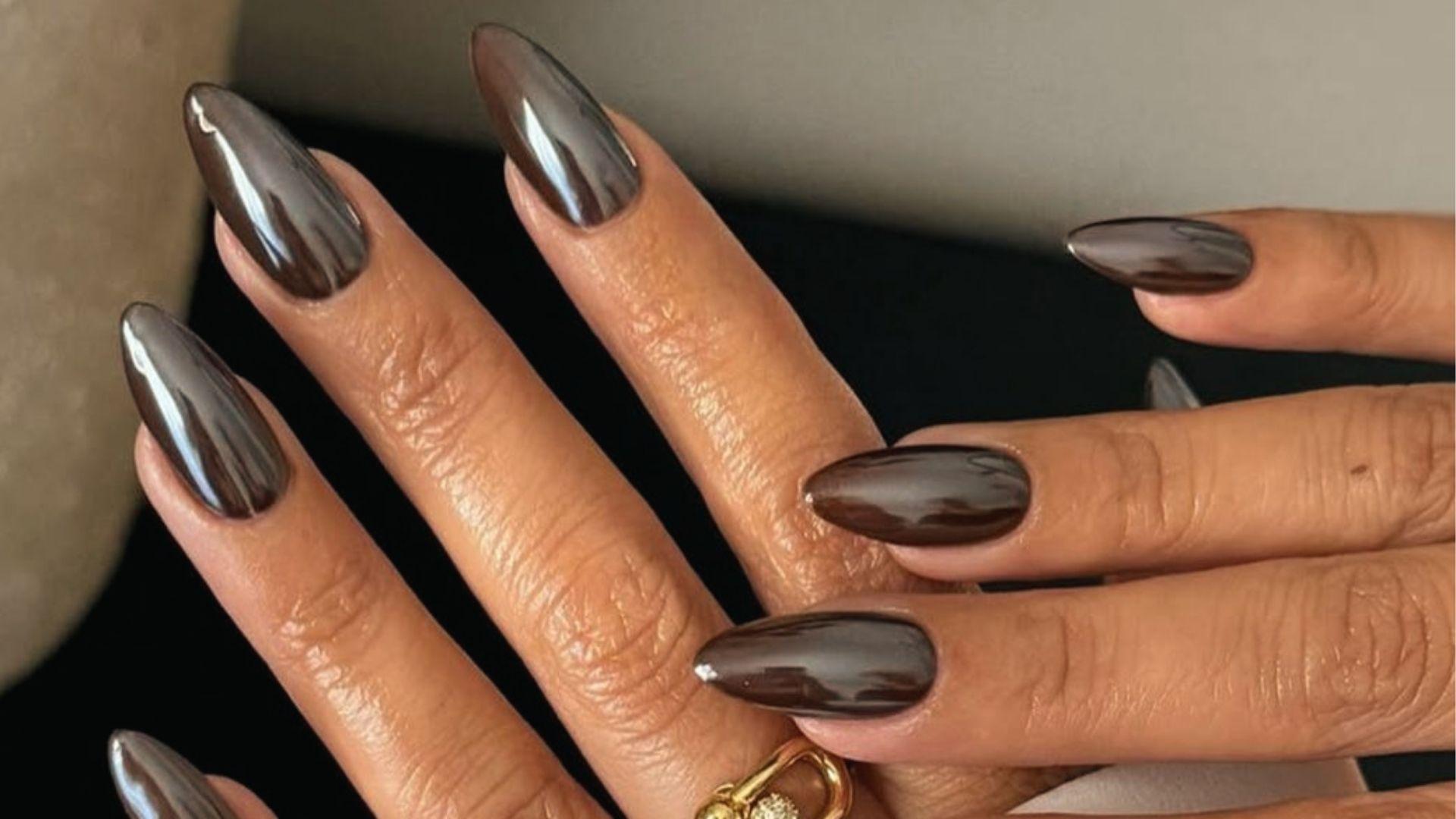 Short almond dip nails in glossy metallic chrome with dark mocha-brown mirror finish on both hands.