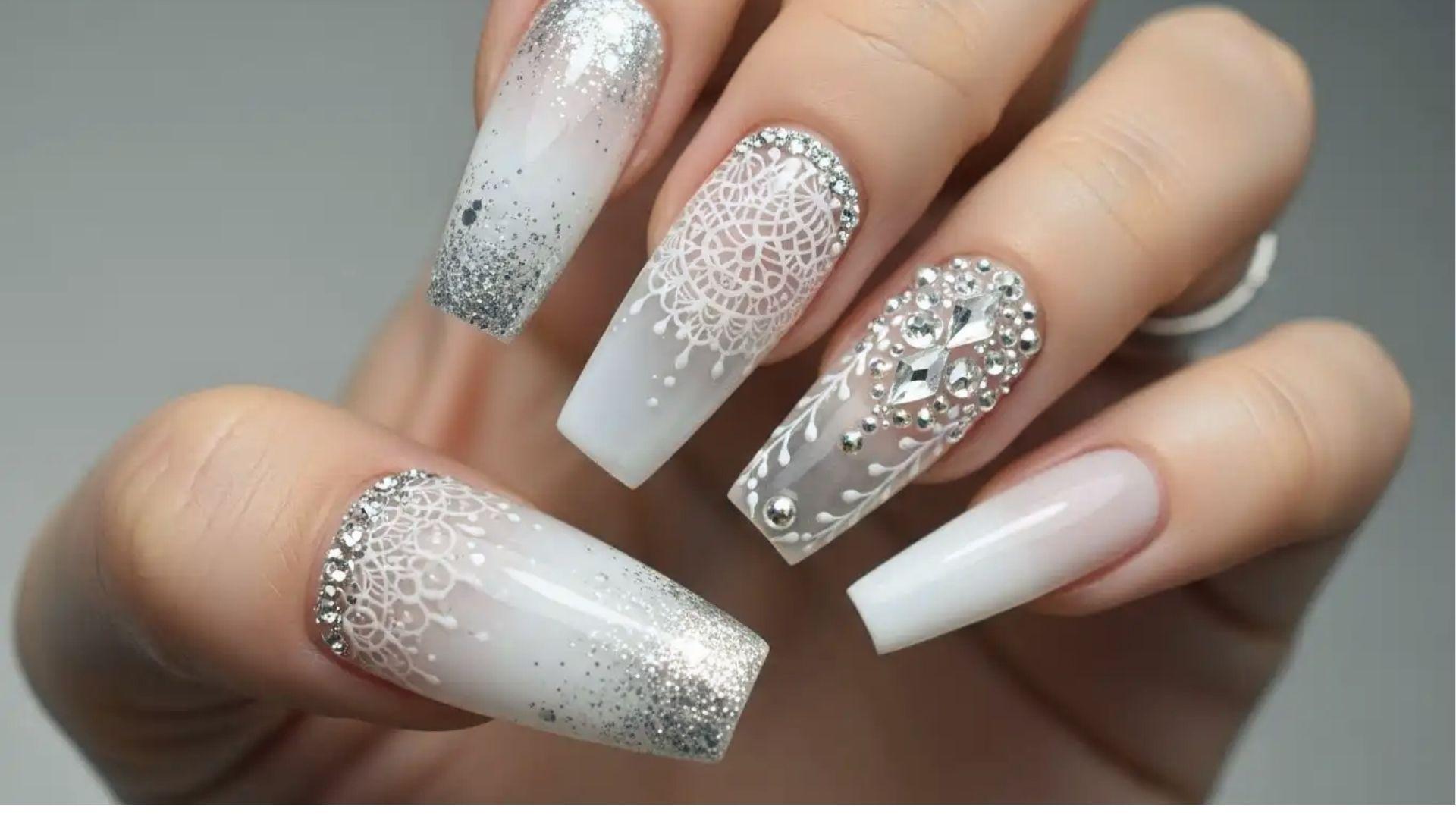Long coffin dip nails in milky white with silver glitter ombre, lace art, and 3D rhinestone accents.