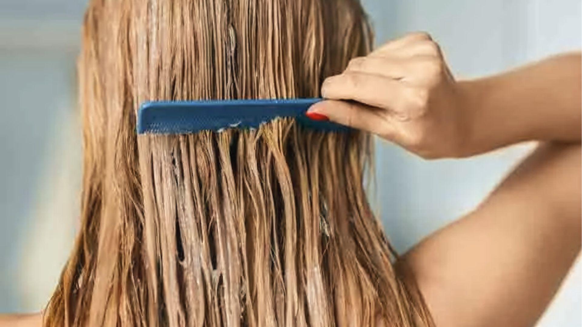 Close-up of saturated blonde hair during bleach processing, showing texture while timing lift.