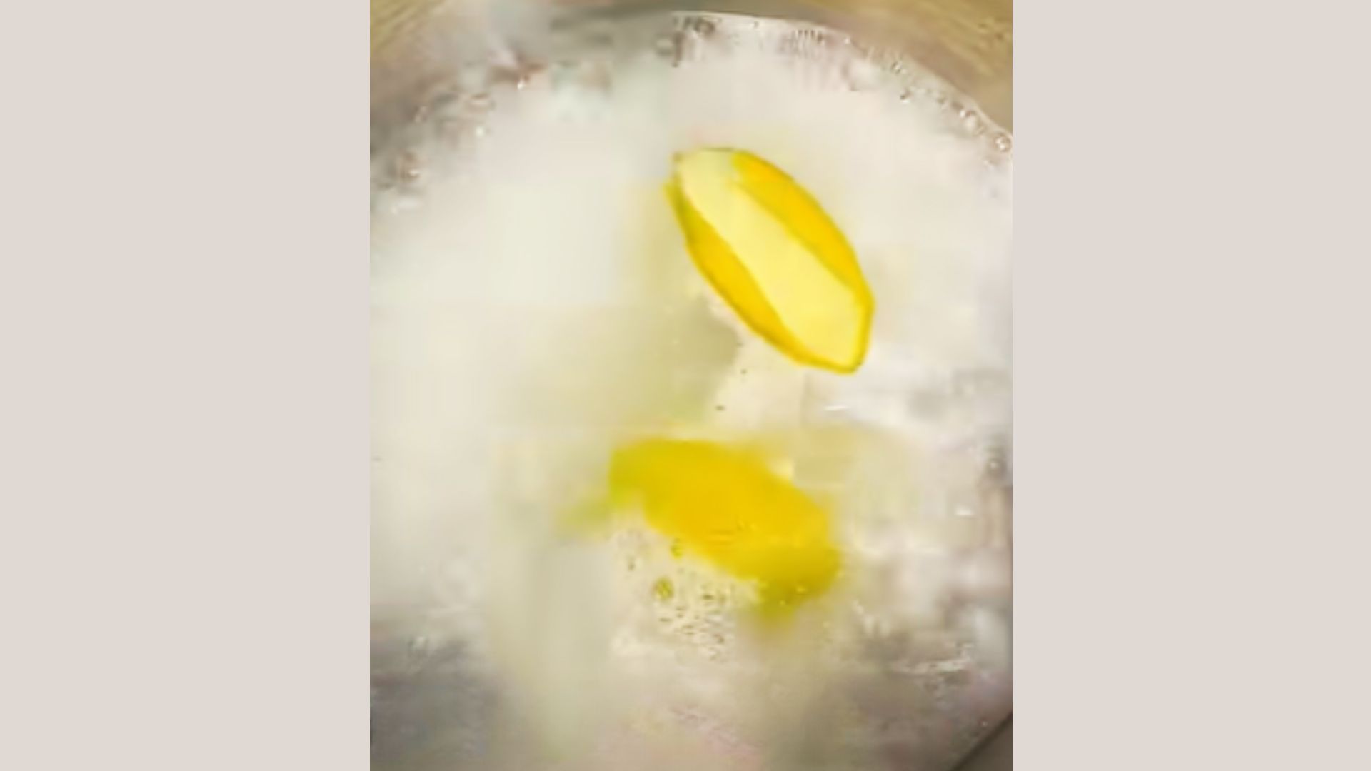 Cooked rice water being strained into a clean container separating liquid from rice grains