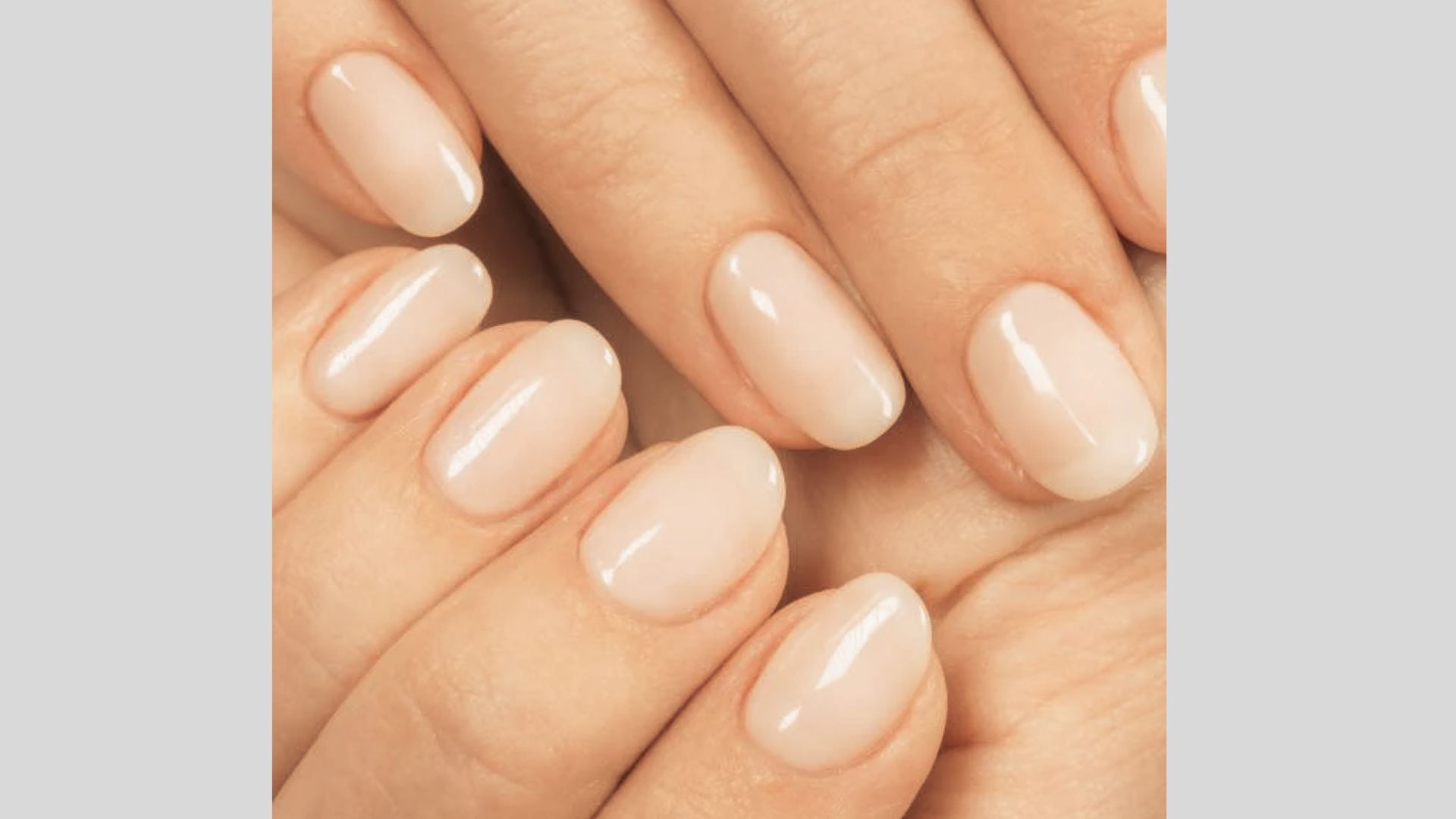 Short oval-shaped nails with a natural-looking sheer nude gel polish and glossy finish.
