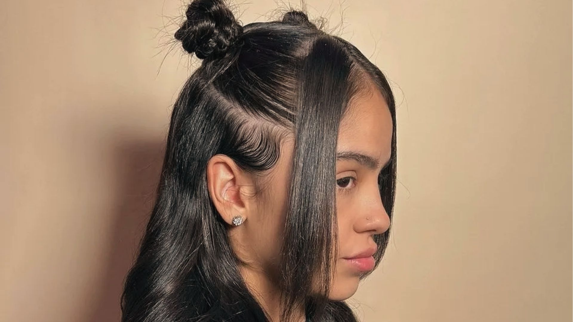 Sleek middle part half up half down style on straight black hair with pearl accents and glam