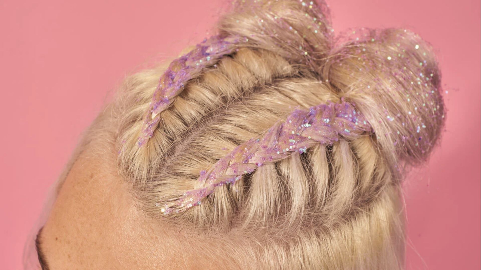 Festival half up half down black style with glitter braids, space buns, and straight hair on pink