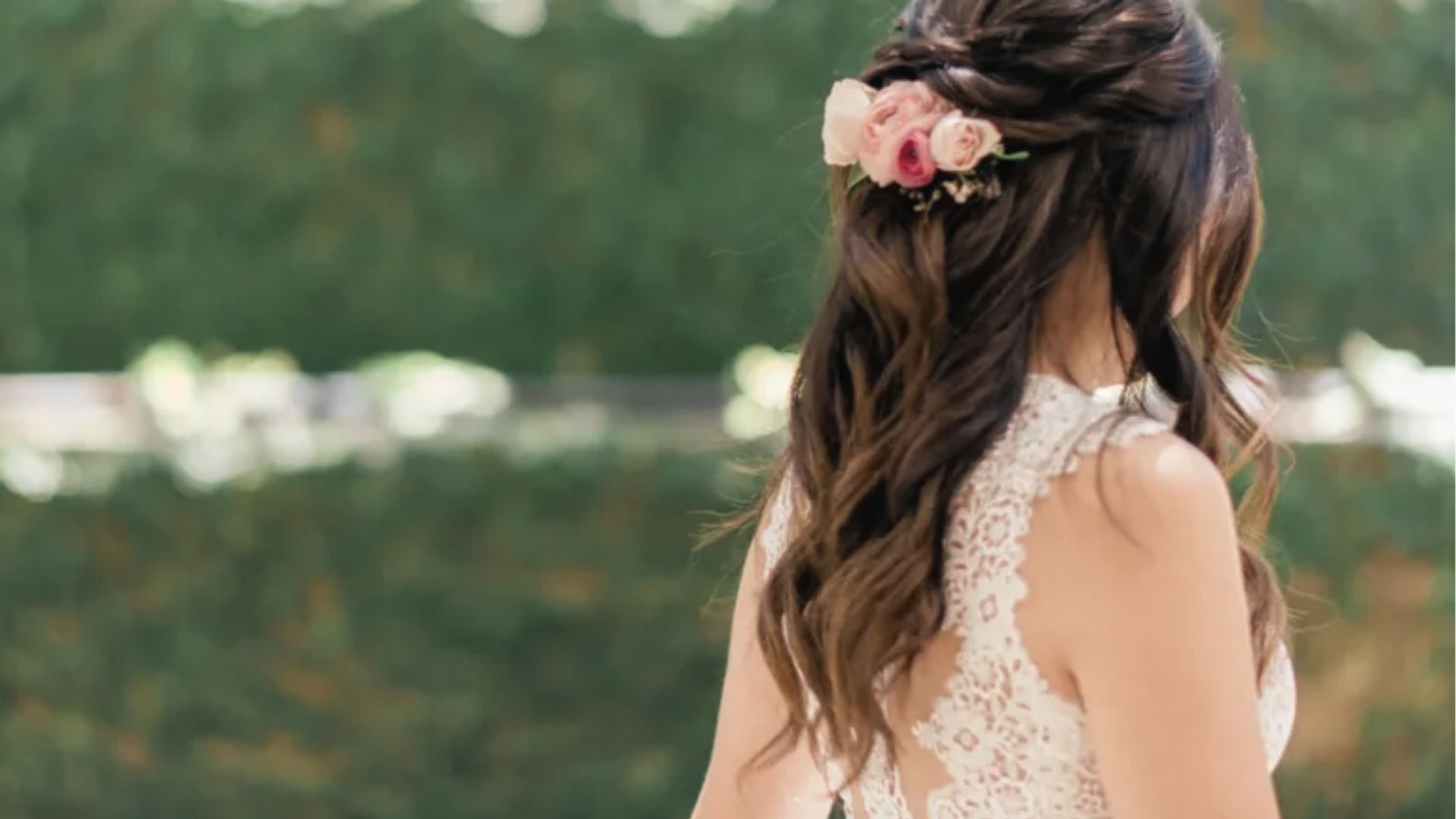Romantic half up half down waves with twisted crown and pink roses for bridal outdoor look